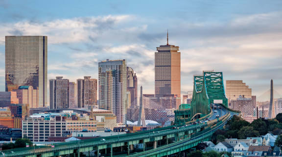 the skyline of the city with a bridge and a train
