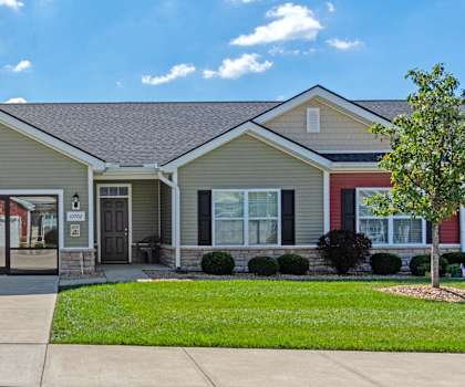 a house with a driveway and a lawn