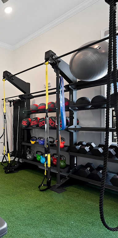 a home gym with a rock climbing wall and exercise equipment