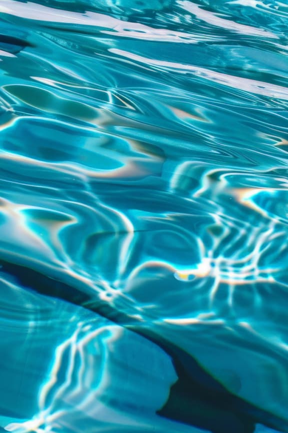 the reflection of the water in the swimming pool at Aspire High Desert Apartments, Victorville, CA