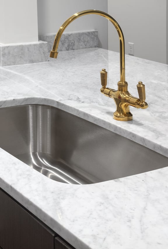 kitchen sink detail with brass fixtures at The Fitz Apartments,Oregon 97210