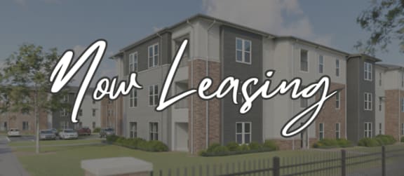 Apartment complex with the words "Now Leasing" prominently displayed.