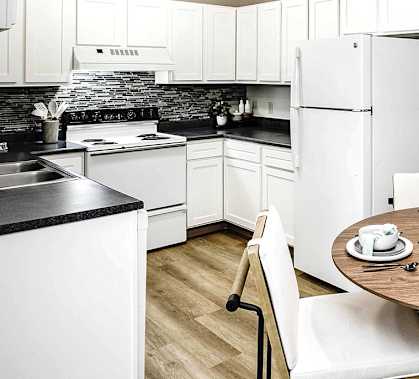 a kitchen and dining room with a table and chairs