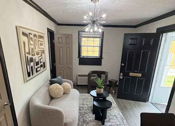 A modern living room with a grey sofa and a rug at Waverly Manor Townhomes, Georgia