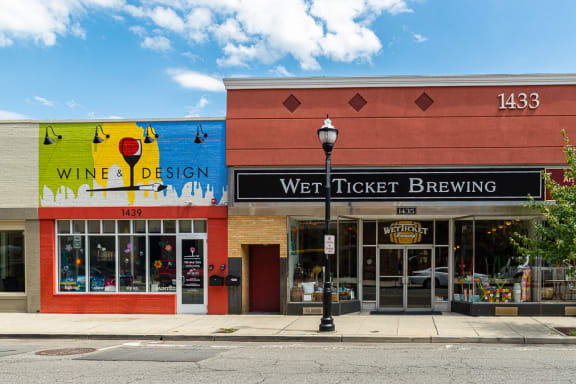 the front of a building with a sign for a wine tasting and a beer store