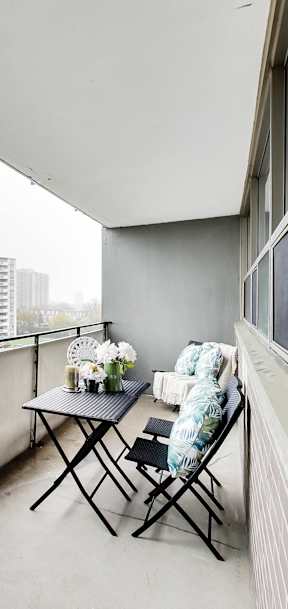 a living room with a couch and a table on a balcony