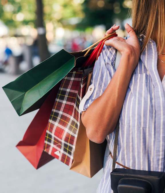 A woman is holding shopping bags in her hands at City-Base Vista, Texas, 78223