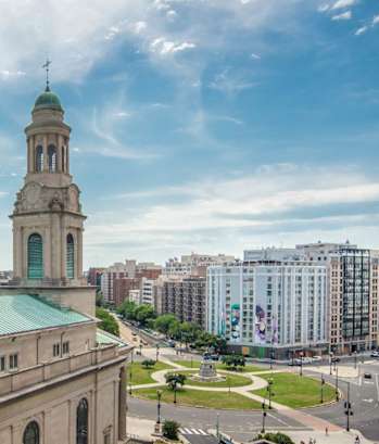 an aerial view of a church tower in a city