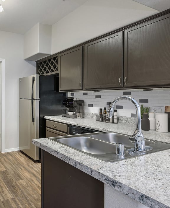 an open kitchen with granite counter tops and stainless steel appliances