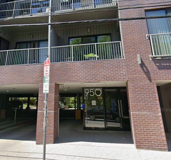 A red brick building with a balcony on the second floor.