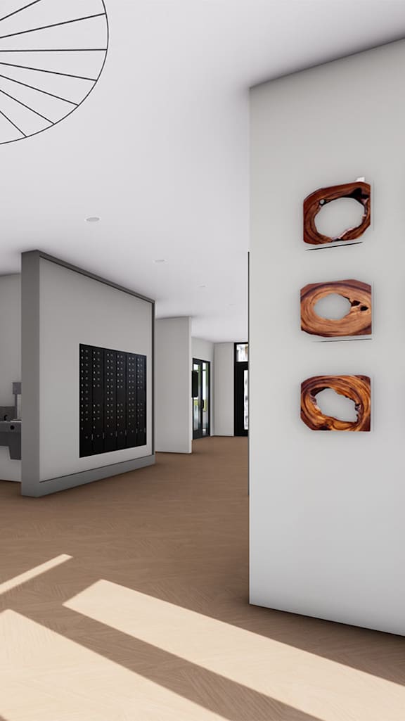 A room with a bench, picture, and framed objects on the wall.