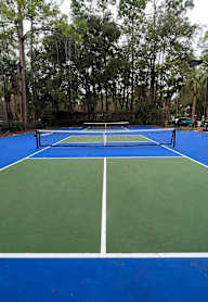 A tennis court with a net in the middle.