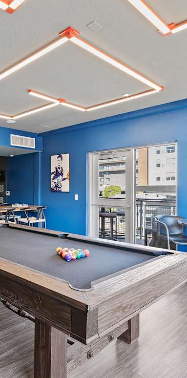 a living room with a pool table and a bar at Paperbox Lofts, Salt Lake City, UT, 84101