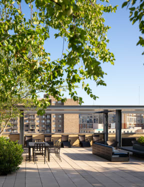 a view of the roof terrace with seating and a pergola