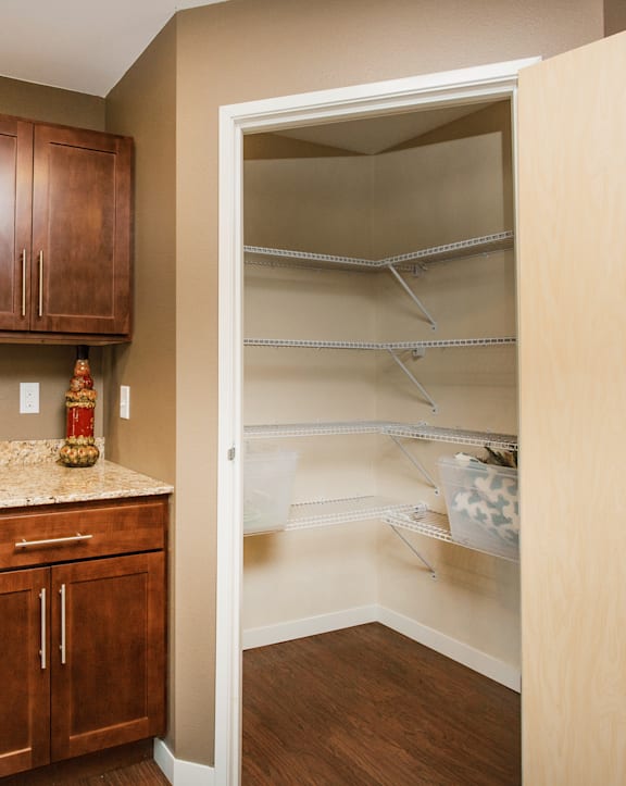 A kitchen with wooden cabinets and a stove top oven.