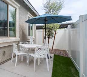A swimming pool surrounded by palm trees and a house at Vistoria At Stadium Apartments, Arizona, 85305