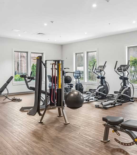 A wall of bicycles is displayed in a room.