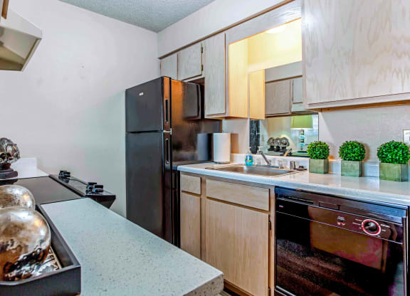 a kitchen with wooden cabinets and stainless steel appliances