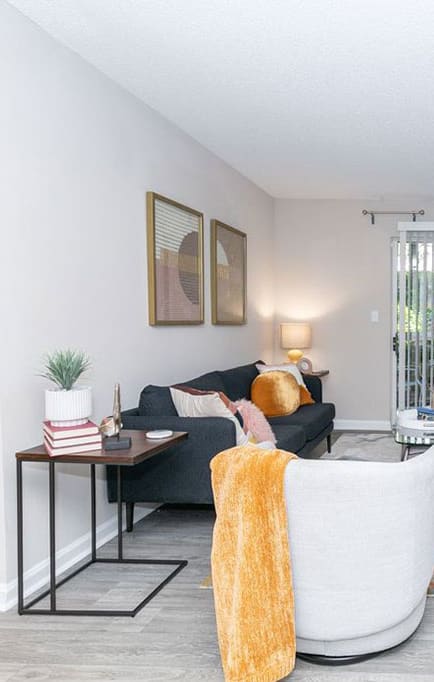a living room with a couch and a sliding glass door