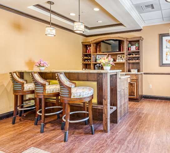 a dining room with a table and chairs and a bar