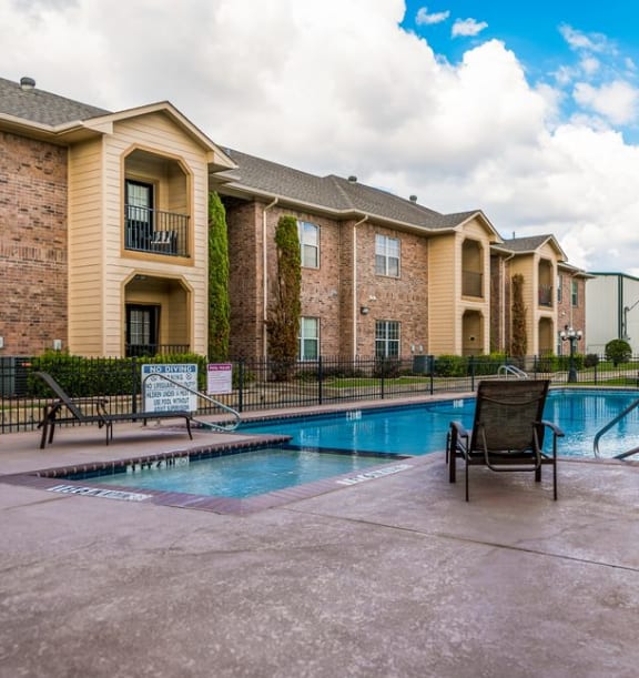 a swimming pool with a chair the corners apartments