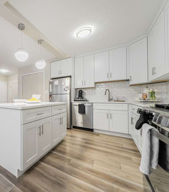 a bedroom with a bed and a ceiling fan at Huntington Green Apartments, University Heights, OH