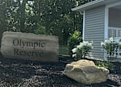 Thumbnail 1 of 36 - a stone sign that reads olympic reserve in front of a house