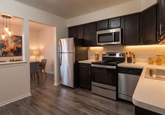 A kitchen with black cabinets and a white countertop.