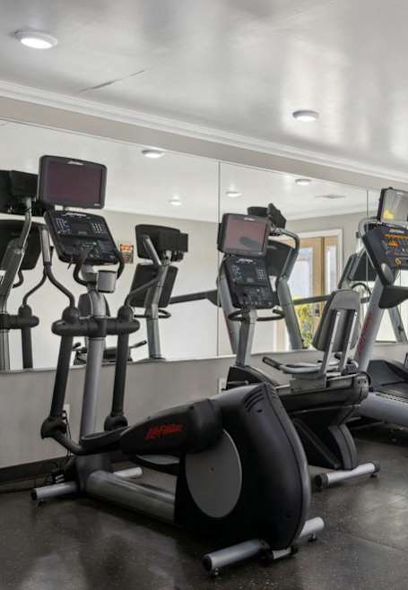 a gym with treadmills and other exercise equipment at Candlewood, Corpus Christi, 78412
