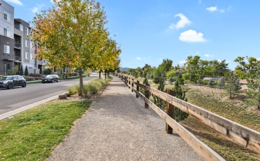 an aerial view of a field with trees and a road at Parkside at Littleton Village, Littleton, 80122