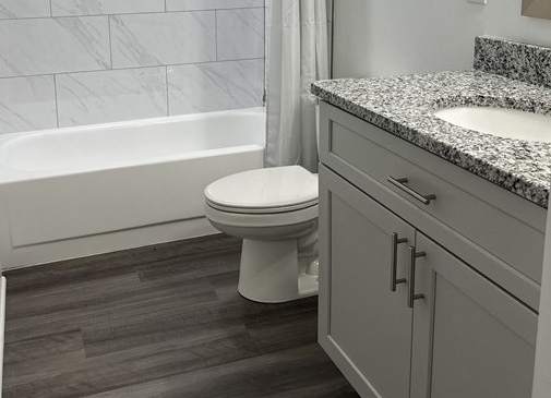 a bathroom with a shower and a toilet in it at Stuart Woods* Apartments, Herndon, Virginia