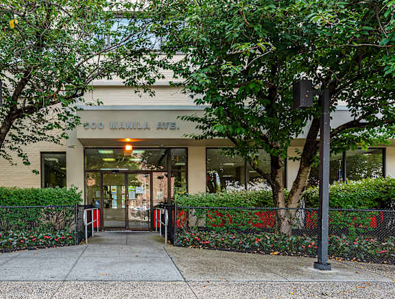 The entrance to a building with a yellow line in front.