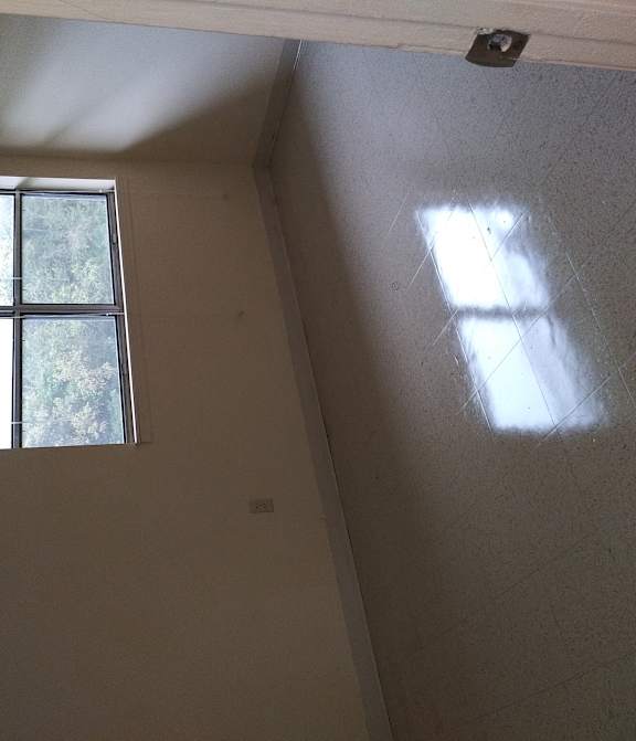 a window on the wall of a room in a house