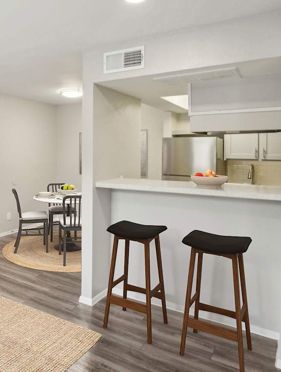 A living room with a white couch, a coffee table, and a bar area.at The Keller, Texas