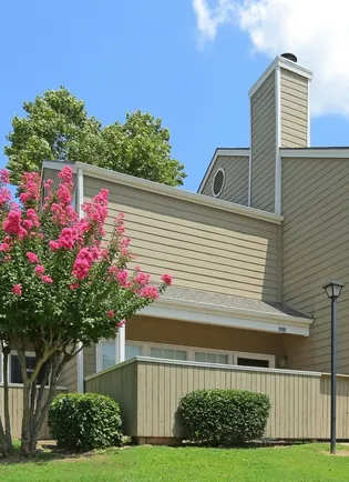 A house with a tree in front of it.