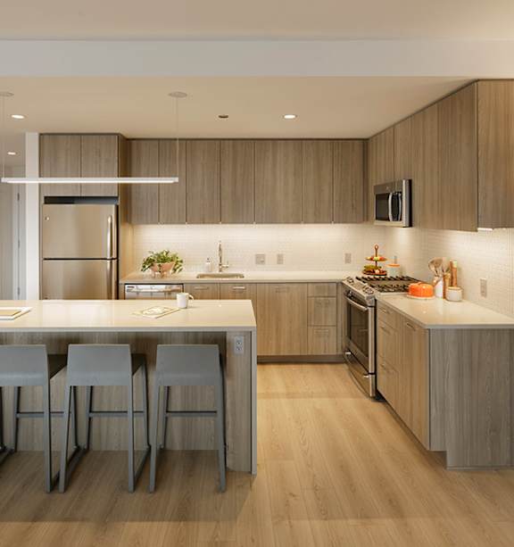 A modern kitchen with a dining table and chairs.