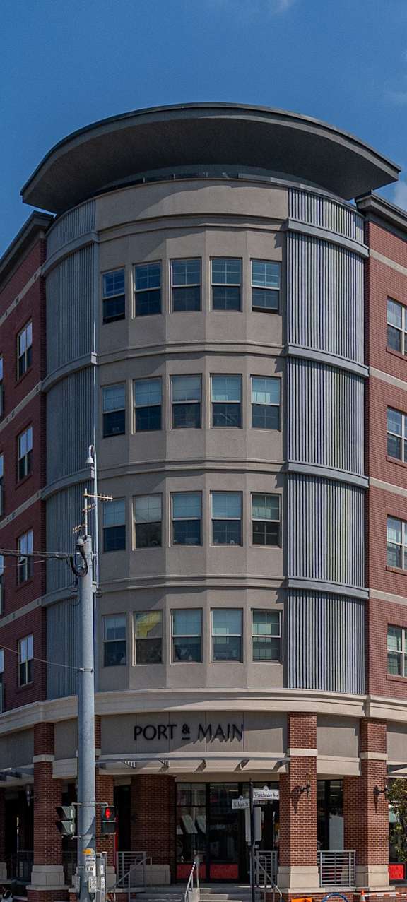 A large building with a curved top is under construction.