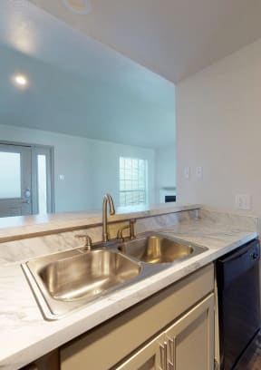 an empty kitchen with a stainless steel sink and counter top