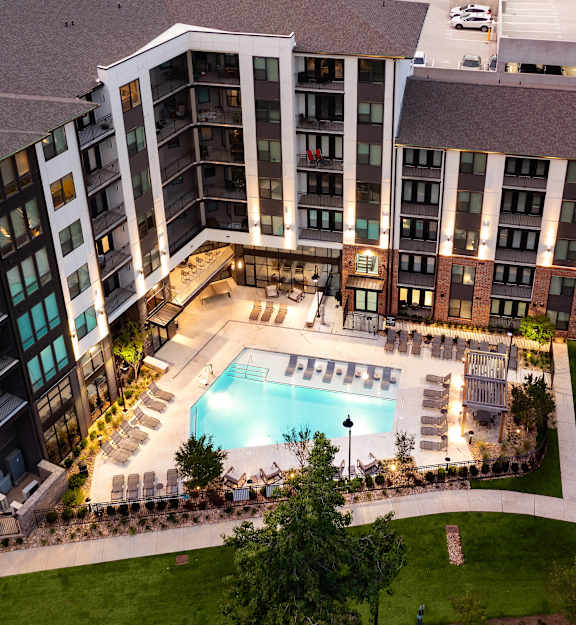 an aerial view of an apartment building with a swimming pool