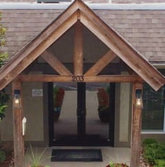 the front entrance to the leasing office of a house with a swimming pool