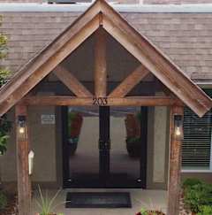 the front entrance to the leasing office of a house with a swimming pool
