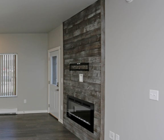 the living room with a fireplace in a bedroom plus den unit. at Mezzo Apartments, Fargo, ND