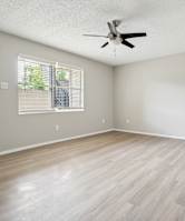 A room with a ceiling fan and a door. at Anson at North Hills, Raleigh