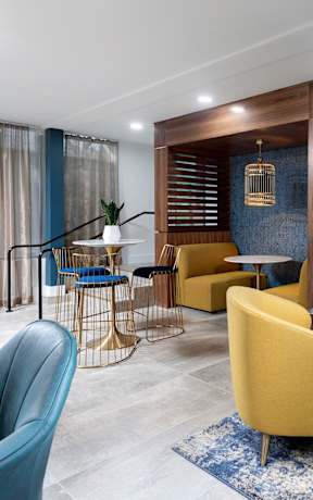 A modern living room with a blue and yellow color scheme.