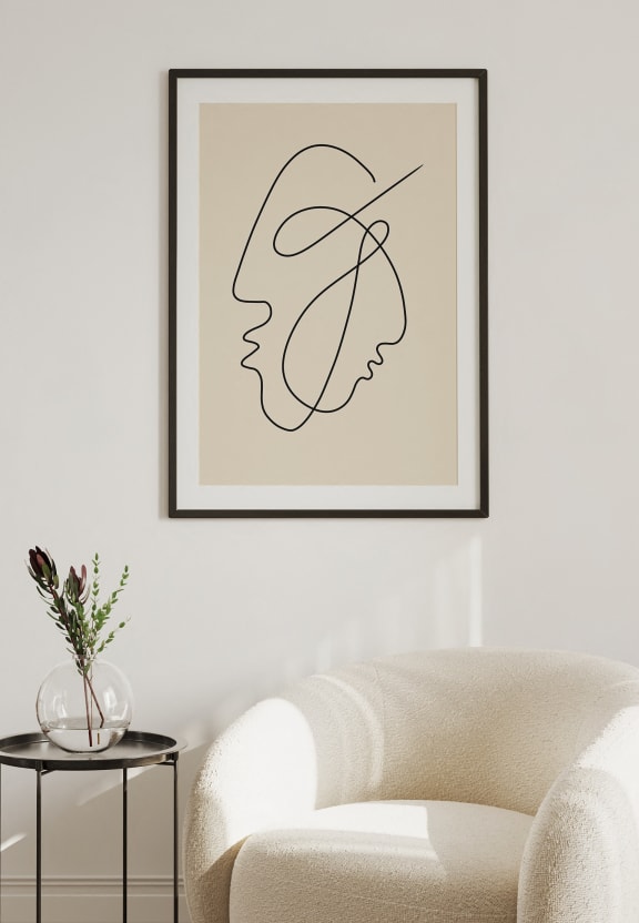 a living room with a white couch and a table with a vase of flowers