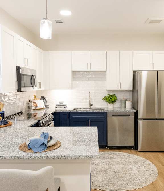 Kitchen with Stainless steel refrigerator at The Crest at Oakwood, Oakwood