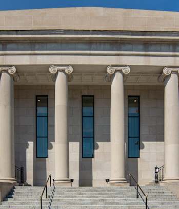 the front of a building with columns and stairs