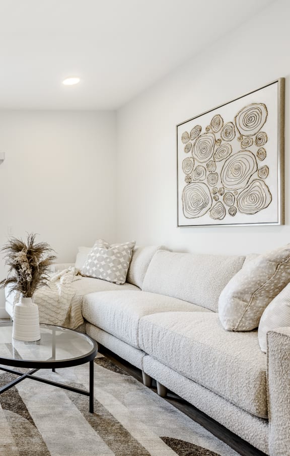 a living room with a couch and a coffee table at The James at Chatham Hills, Westfield, IN
