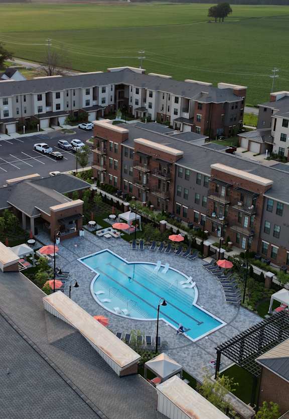 arial view of a swimming pool in the middle of a city
