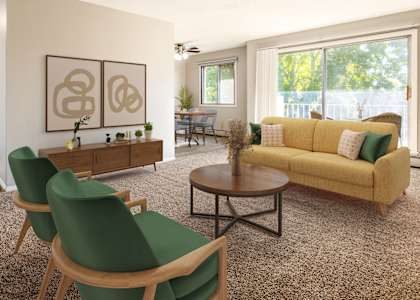 a living room with a yellow couch and green chairs